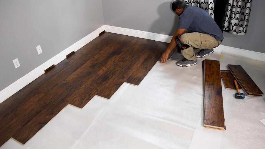 wood flooring being installed over subfloor