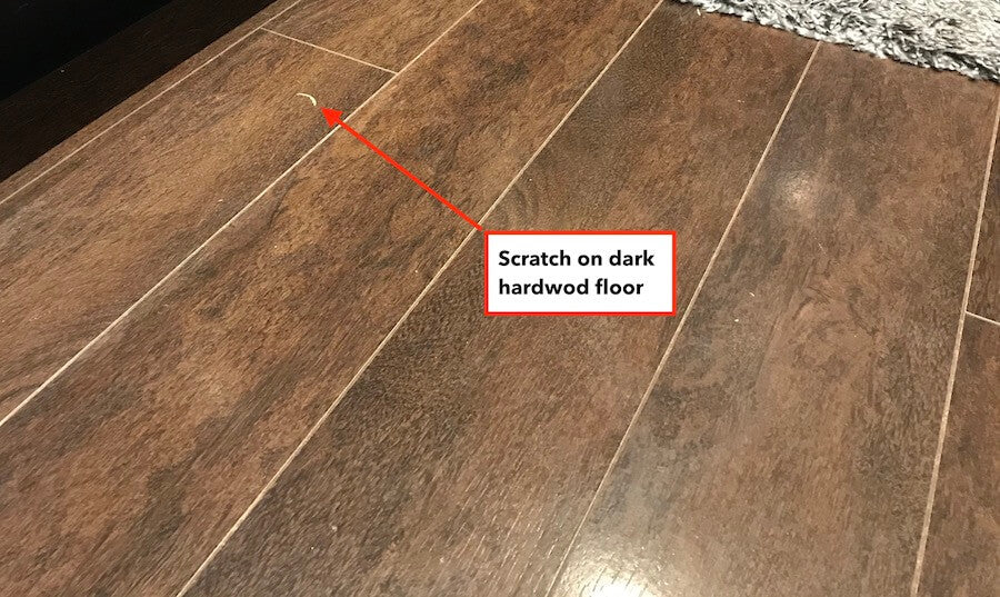 scratch on dark hardwood floor