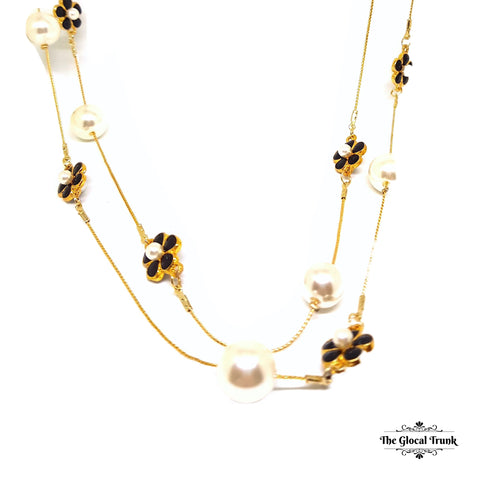 https://www.theglocaltrunk.com/products/pearl-and-black-enamel-flower-long-chain-necklace