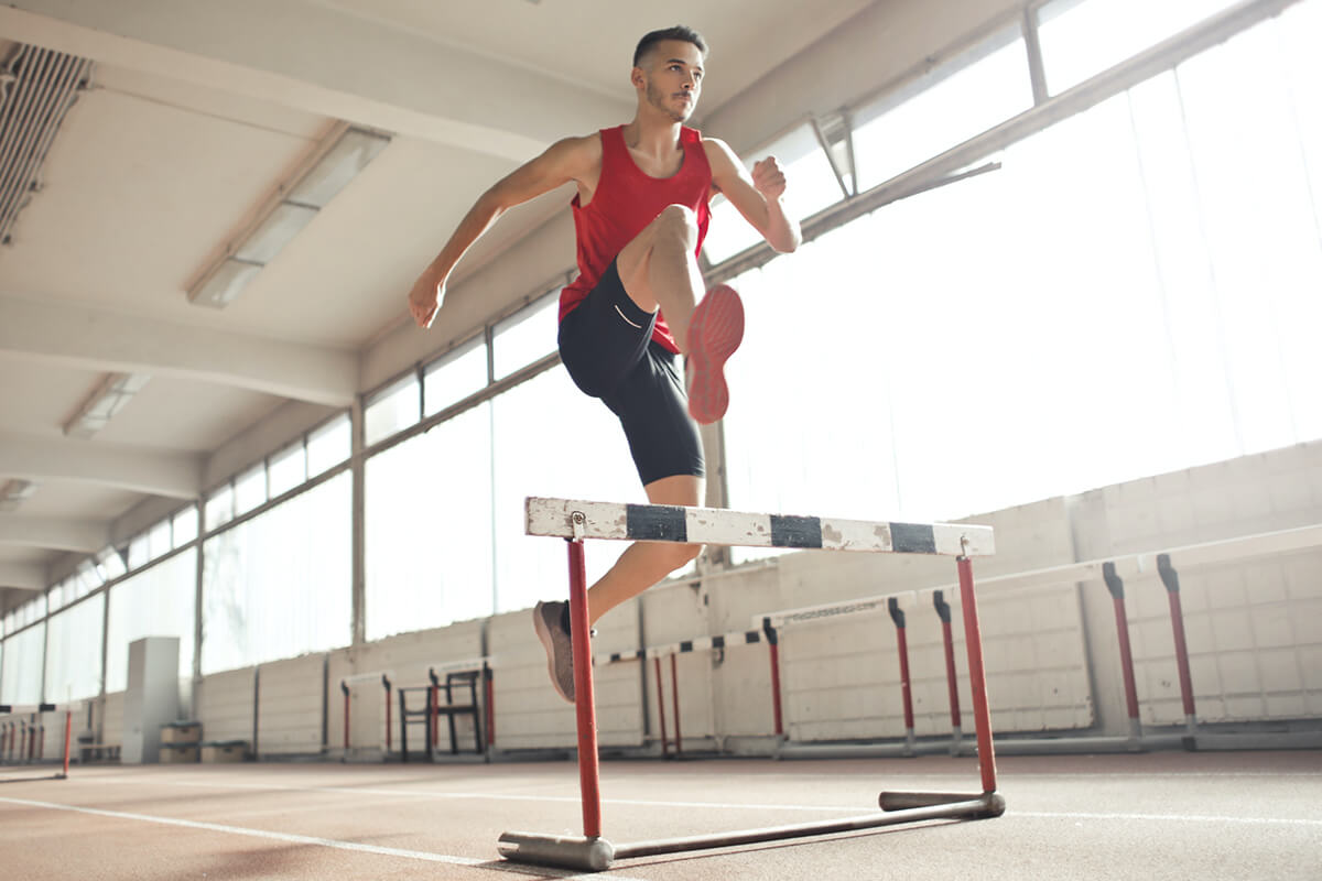 Athlete jumping over a hurdle