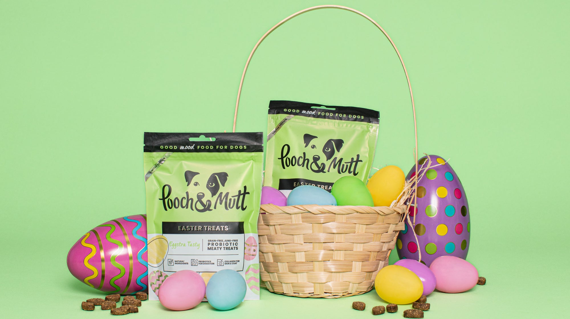 Easter treats and eggs with a basket on a green background