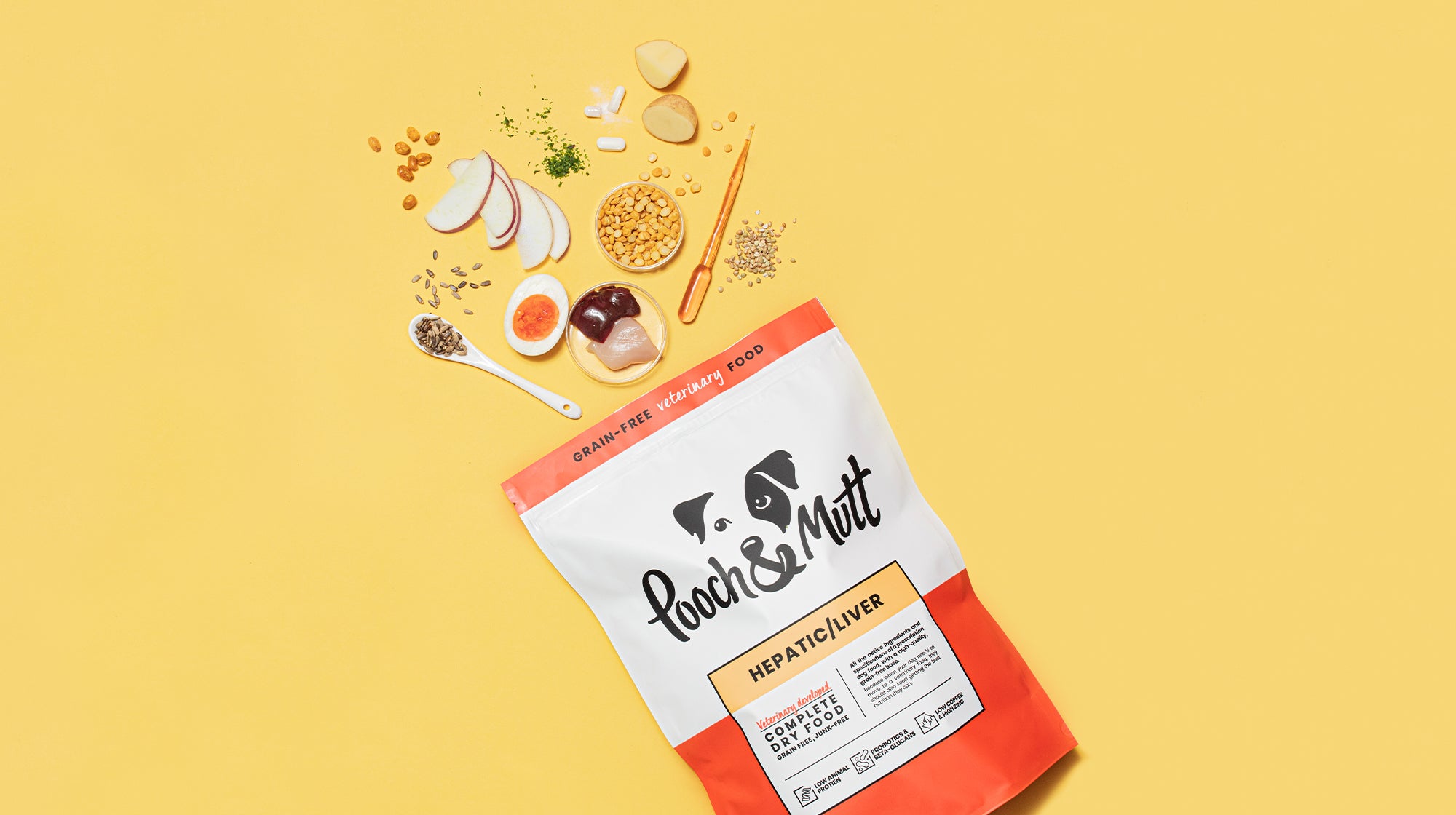 A packet of our Liver Food, with all raw ingredients within the food spurting out from the packet, against a pale orange background