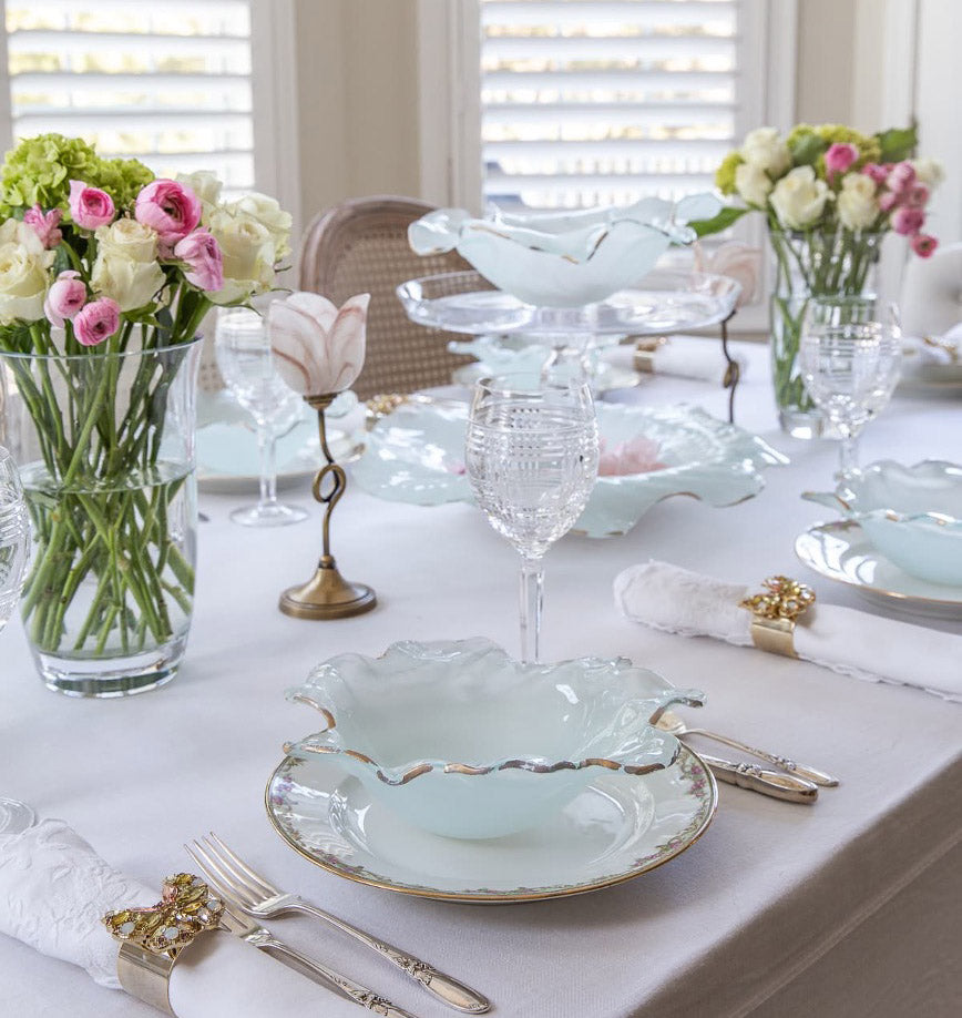 Gorgeous tablesetting for easter, colorful flowers, frosted bowls for the dinnerware