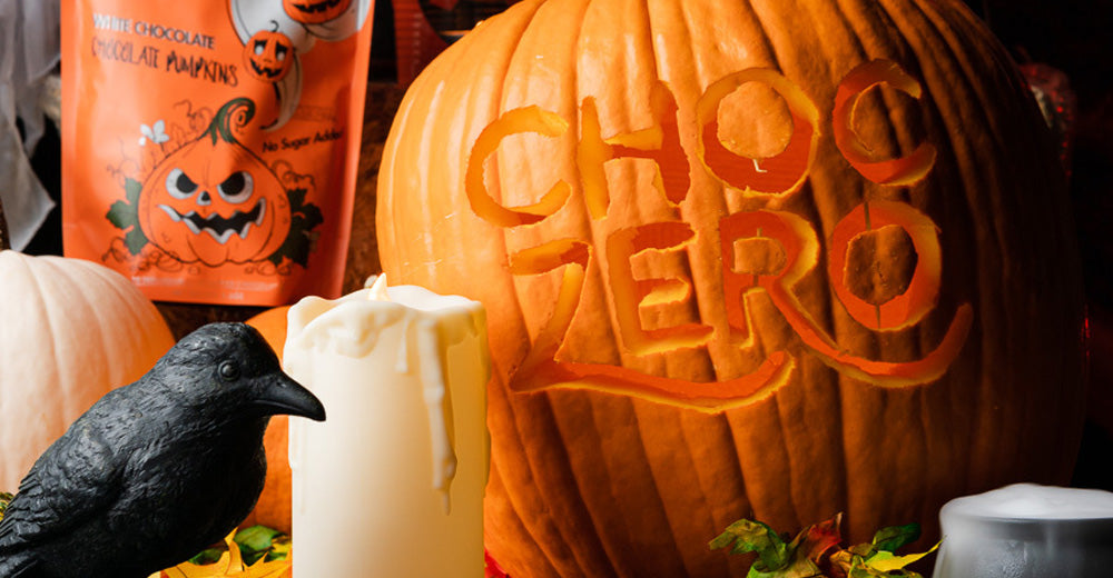 A pumpkin carved with the words ChocZero with chocolate pumpkins in the background