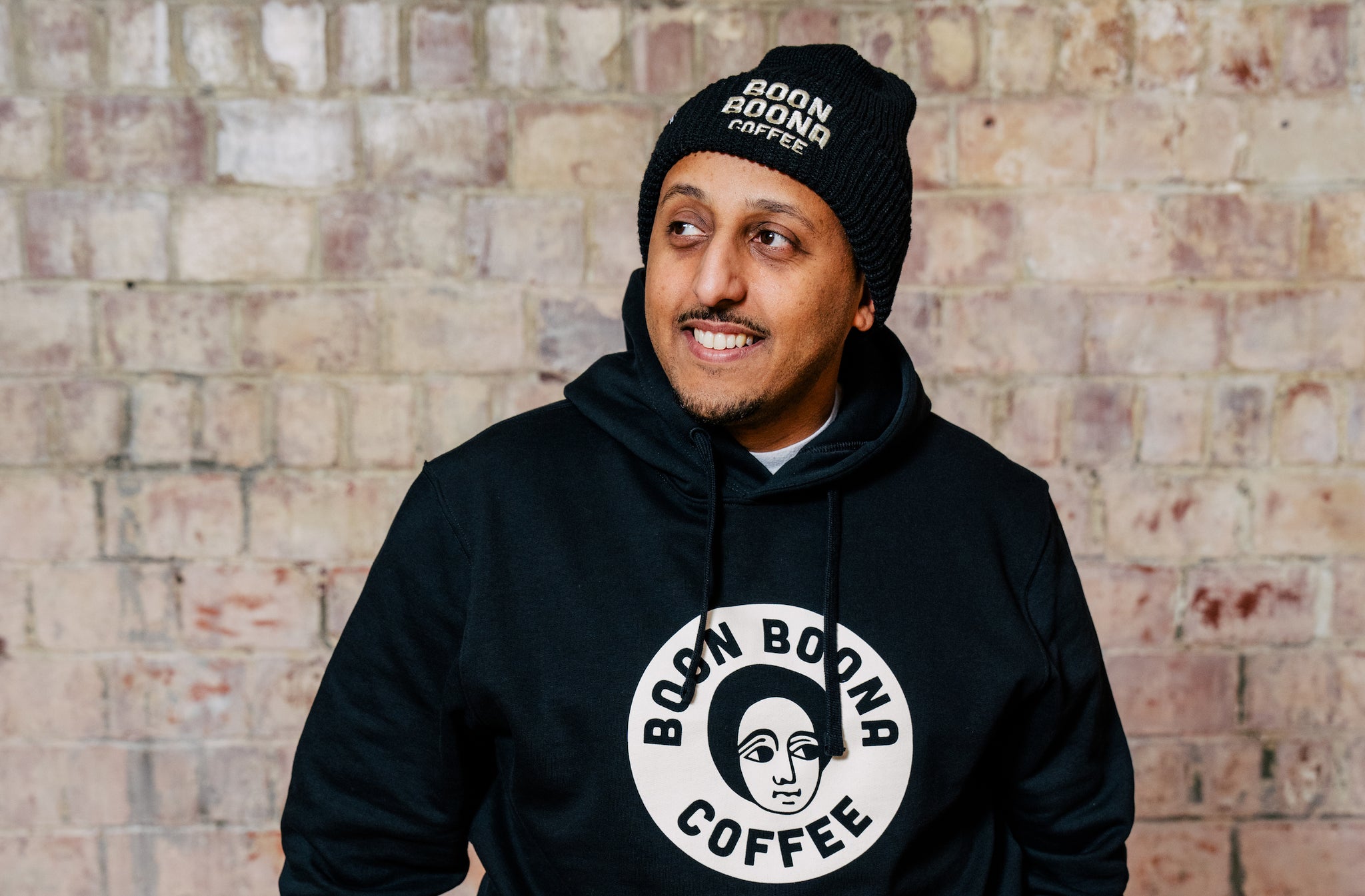 Efrem of Boon Boona Coffee wearing a custom MiiR hoodie and beanie