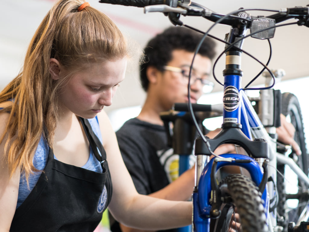 Two children working on bikes