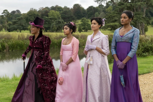 Bridgerton ladies walking in colorful regencycore dresses