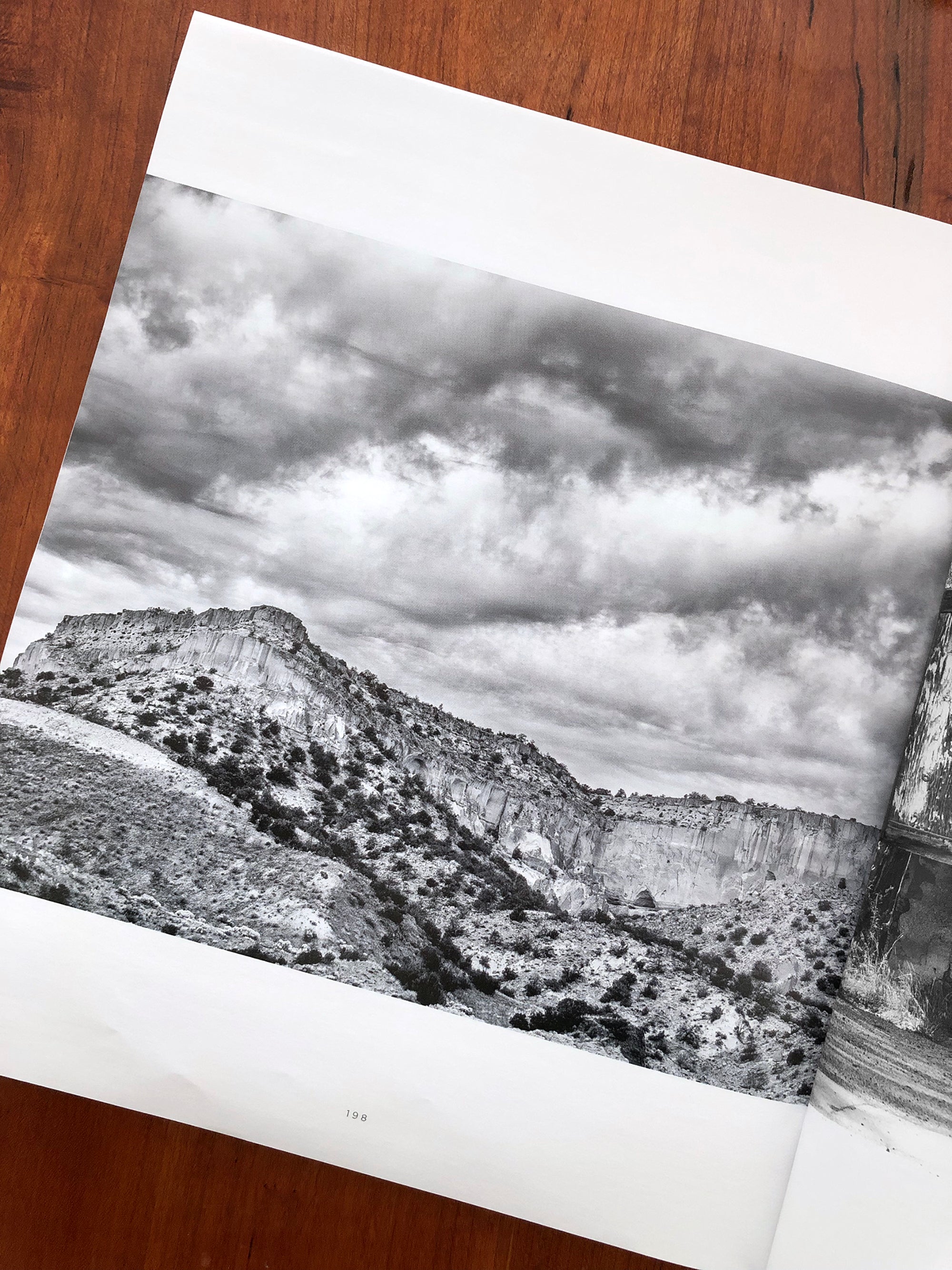 A  black and white landscape photograph of a rocky mesa shot in New Mexico