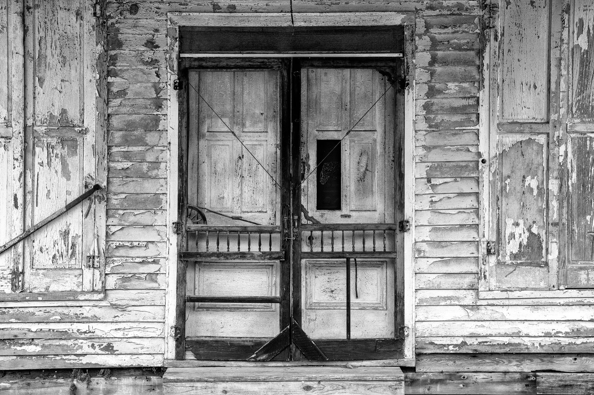 front doors of an abandoned old country store in Mississippi - Black and white photograph by Keith Dotson. Buy a fine art print.