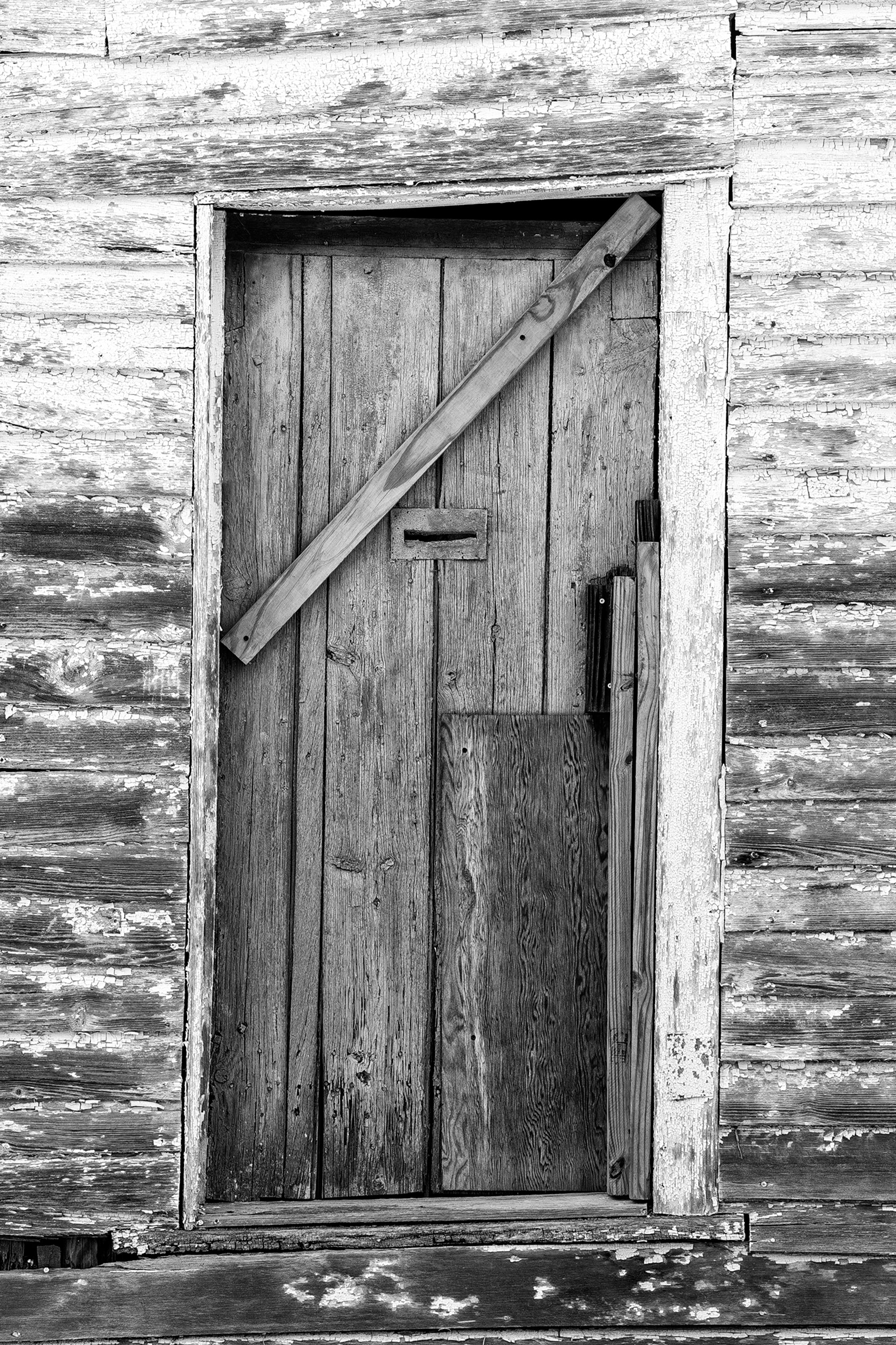 Turquoise Wooden Door with Mail Slot - Black and white photograph by Keith Dotson.