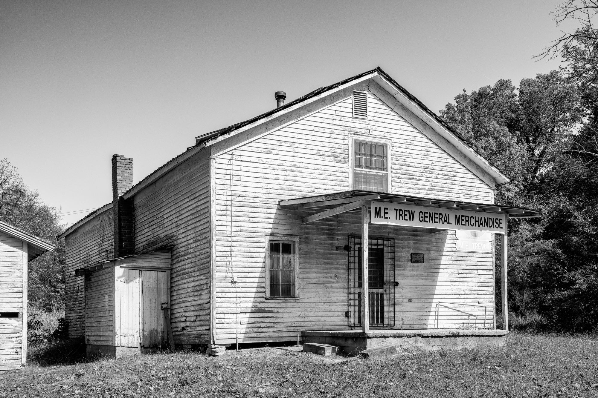 M.E. Trew General Merchandise Store - Black and White Photograph by Keith Dotson