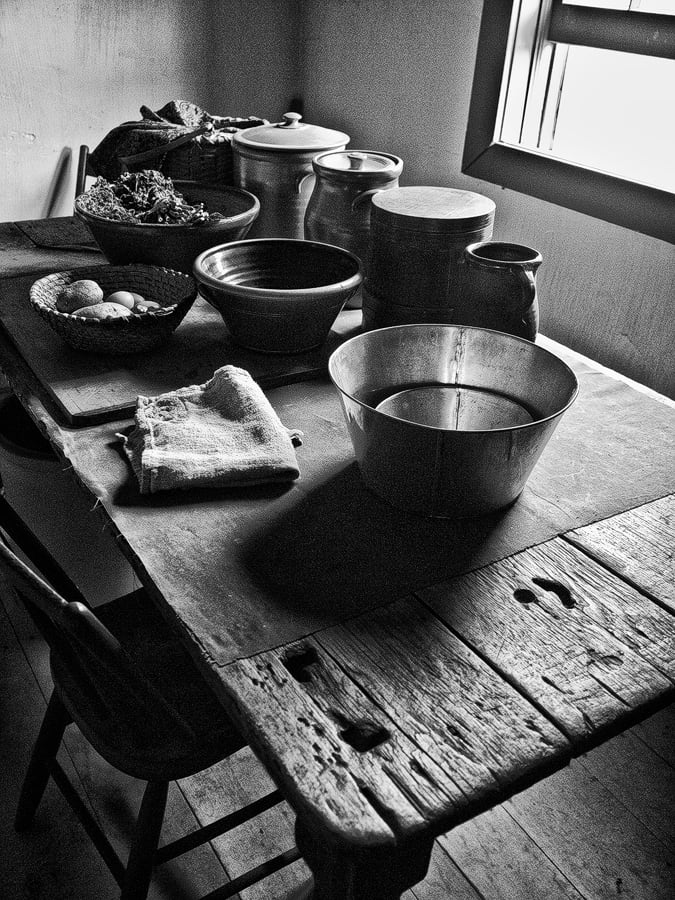 Rustic Farm Table, a black and white photograph by Keith Dotson, can be seen on the wall at Bogartz Food Artz in Atlanta