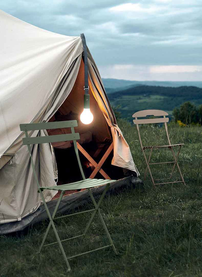 handheld Fermob Aplo Lamp on suspenstion strap hanging from tent