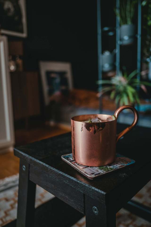 copper mug placed on a back steel chair stool