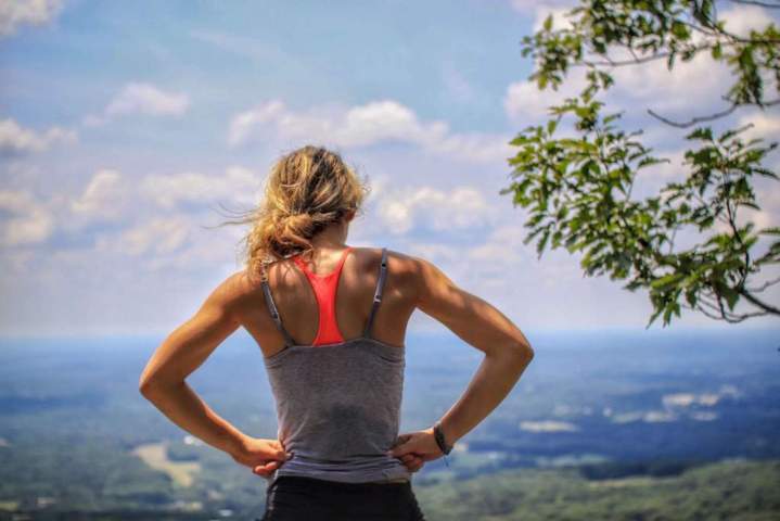 woman wearing athletic attire back to the camera facing view