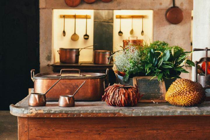 copper cooking items placed on a brown island kitchen counter