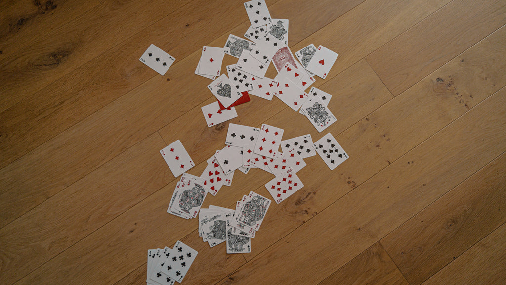 Playing cards scattered across the floor 