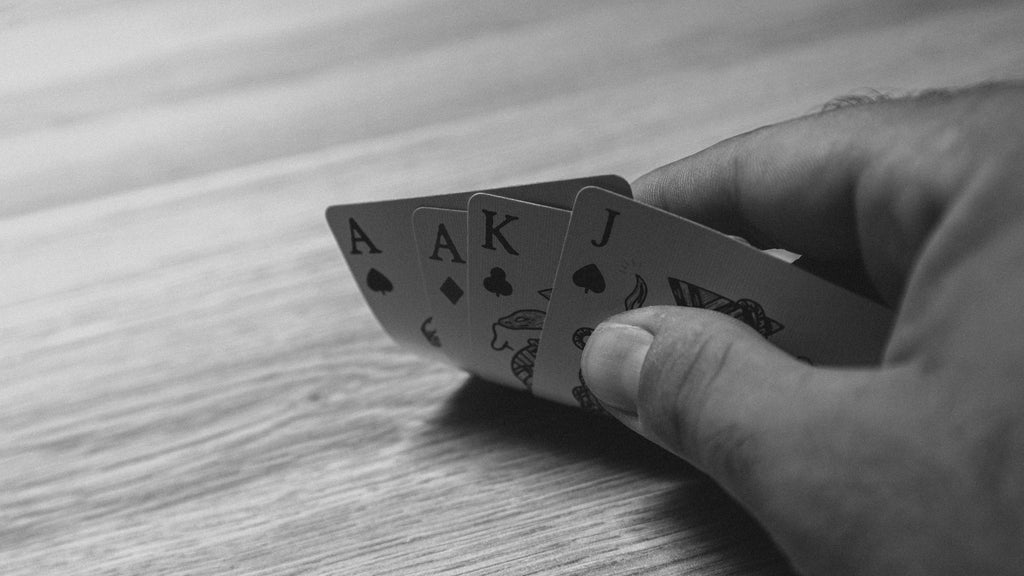 Hand of poker on a wooden table