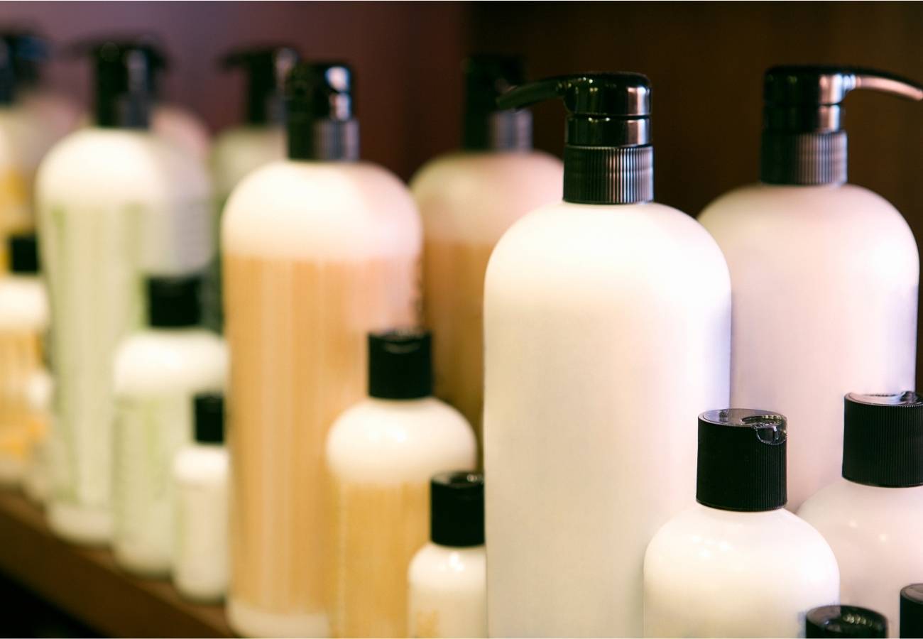 Cosmetology-shampoo-bottles-on-a-retail-shelf-BEAUTY-IN-The-Raw