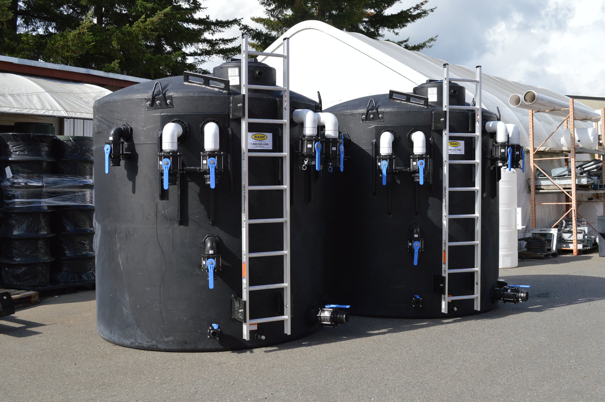 Picture of two mechanical erosion and sediment control tanks. These tanks are fitted with a variety of inlet and outlet fittings, ladders and more.