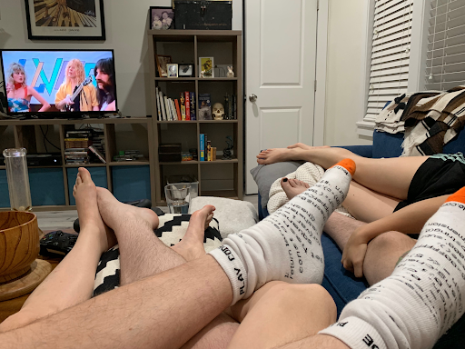 Image of multiple people's legs tangled on a couch
