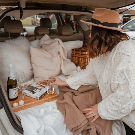 Women setting up a picnic in back of car