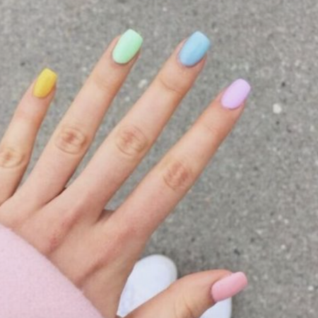 Hand with bright pastel coloured nails