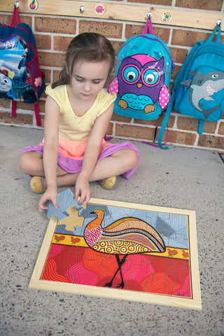 child playing with an education national oz publishing jigsaw puzzle