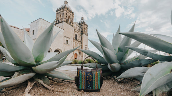 Nena & Co. Mexico Tumbled Leather Bag in front of a church in Oaxaca, Mexico