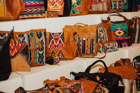 All different kinds of Nena & Co. bags organized on shelves.