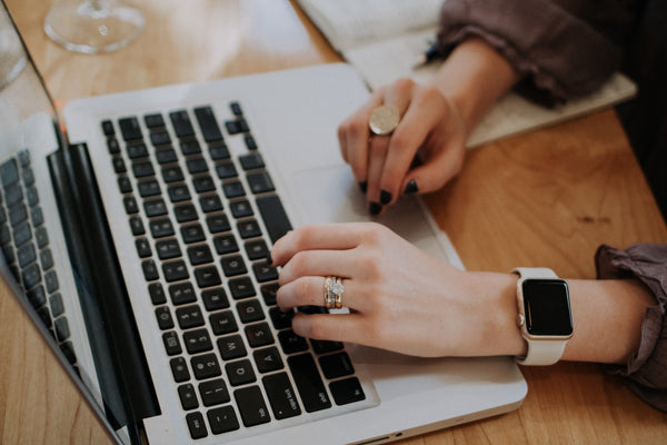 Lady typing at a computer.