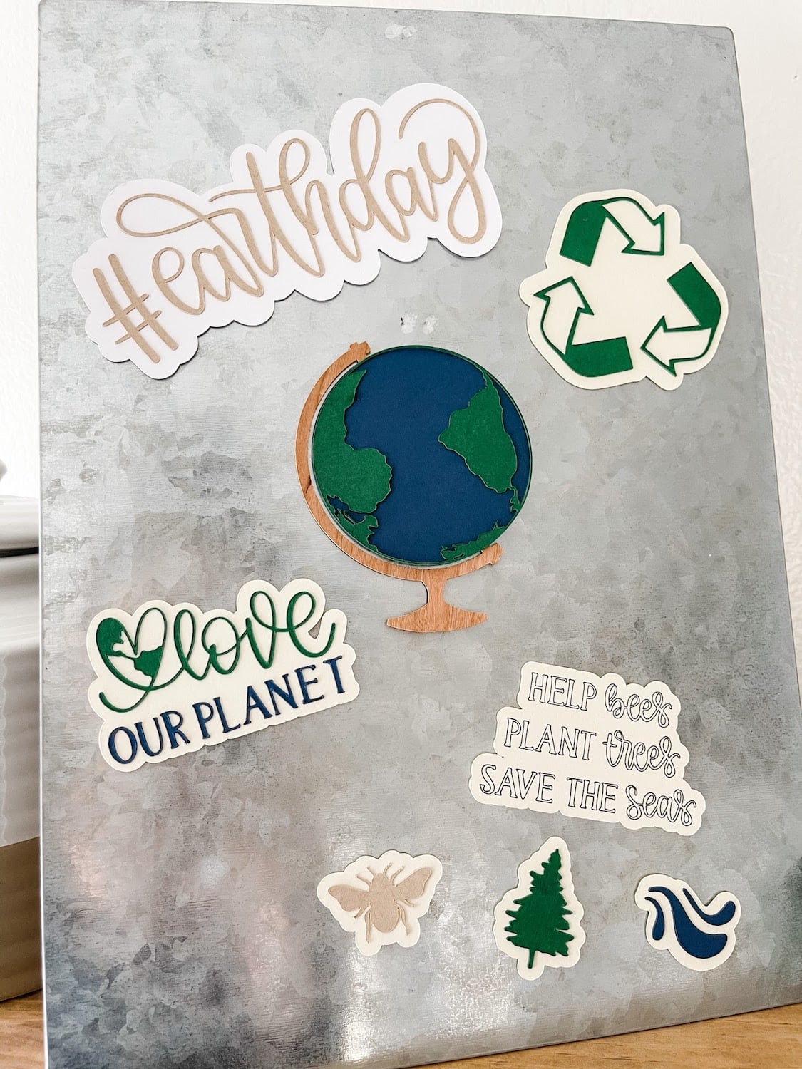 Finished earth day magnets on a metal board