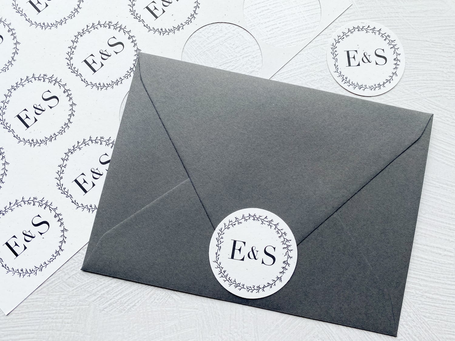 circle monogram attached to envelope flap