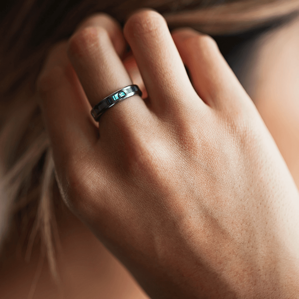 A woman's hand wearing a ring.