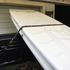 Grey Duck paddle board in the back of a truck.