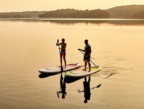 Stand up paddler boarders on a calm lake