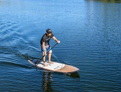 Paddleboard Direct Customer Experience Manager Glenn Morton paddleboarding on a lake