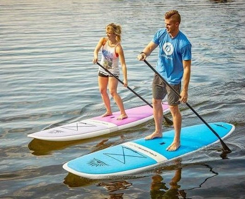 stand up paddle boarding on rigid boards on a lake