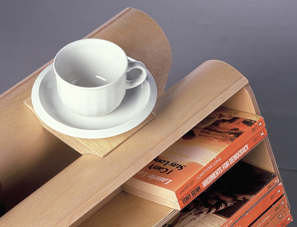 Coffee cup tray sitting atop curved bookcase