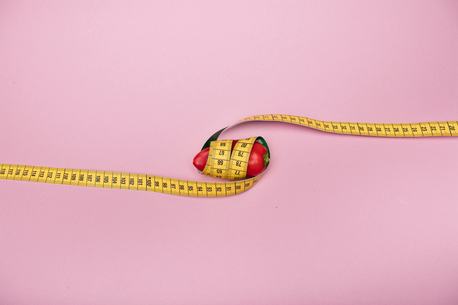 photo of hot pepper wrapped with measuring tape to portray small penis size