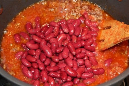 Adding the crushed tomatoes and red beans