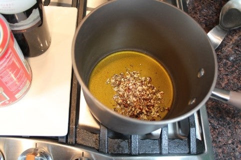Blooming the Grate Grinds New York Red Sauce spice mix in oil.