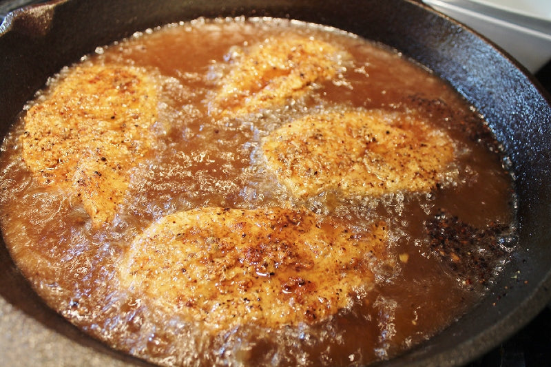 Chicken continued to fry after being turned over in the oil.