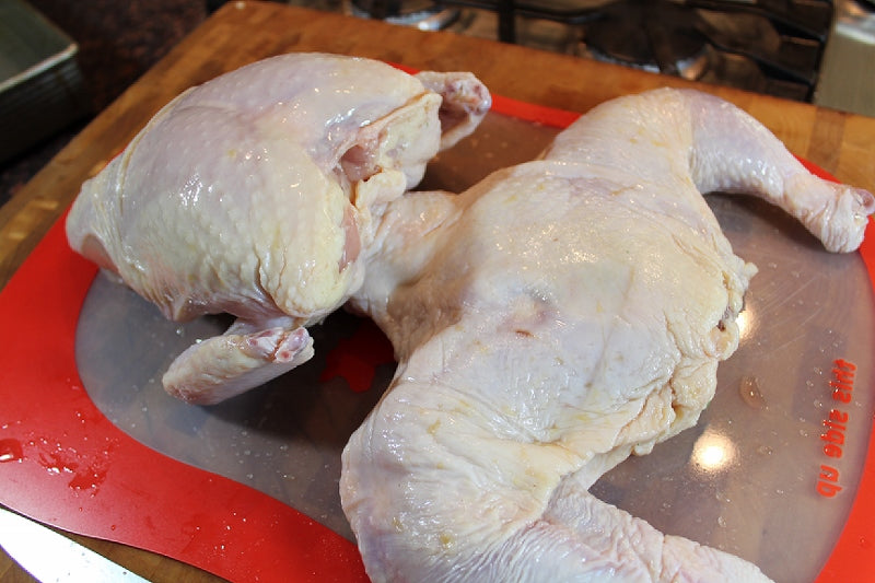 Turn the chicken over and press down to finish flattening out the chicken.