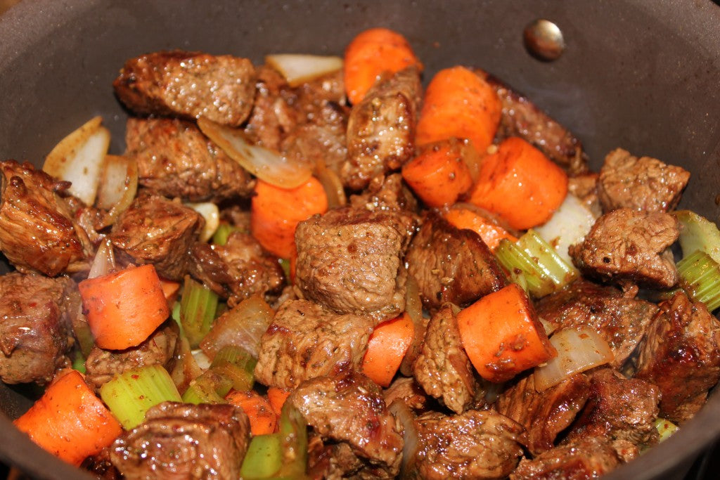 Adding the beef into the mirepoix.