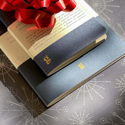 Goldleaf Journals wrapped in a red christmas bow