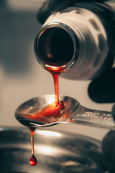 red liquid poured into spoon