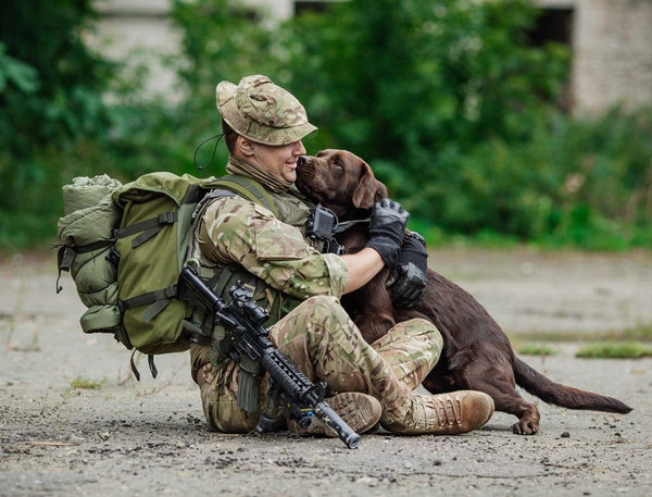 Soldier hugging dog