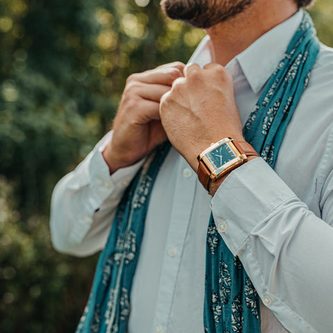 Square watch with black dial and gold case from SÖNER - on arm