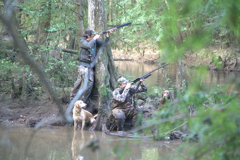 Hunters in camouflage and hunting dogs